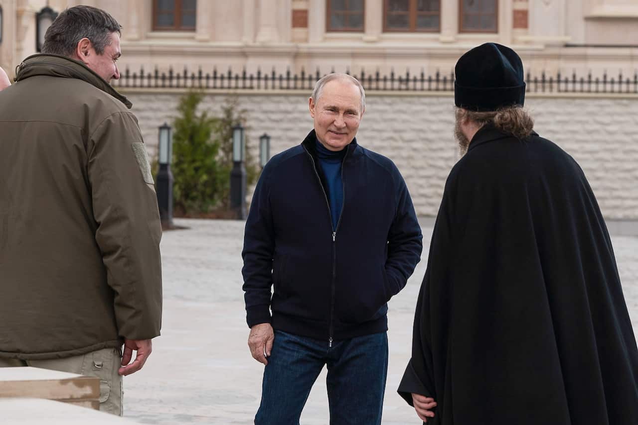 Three men standing outside.