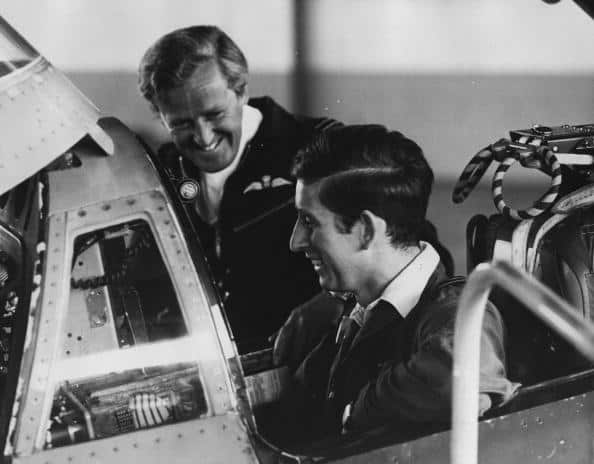 Prince Charles sits in a Phantom Interceptor jet fighter plane as an instructor stands next to him, in 1971.