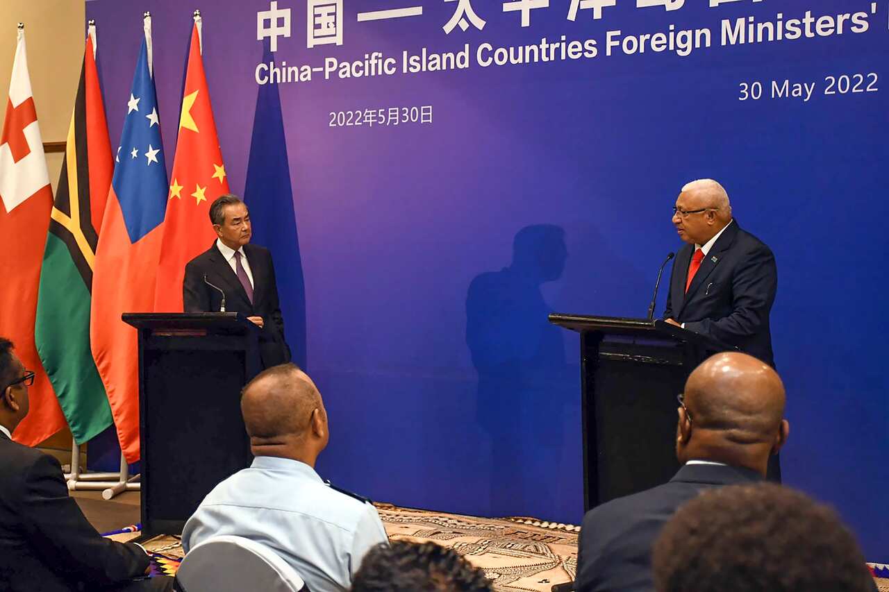 China's Foreign Minister Wang Yi (left) and Fiji's Prime Minister Frank Bainimarama (right) speak at joint press conference
