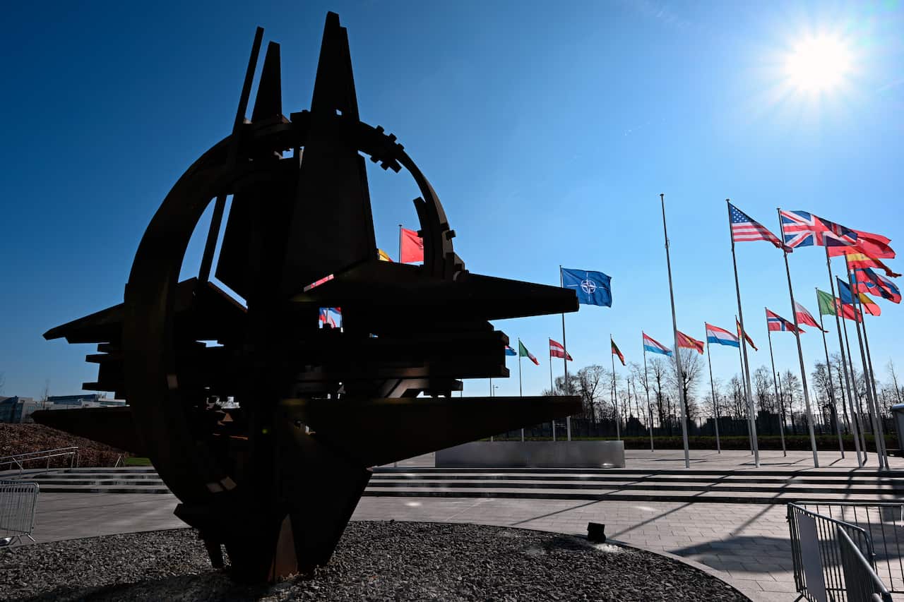 A empty mast among flags.