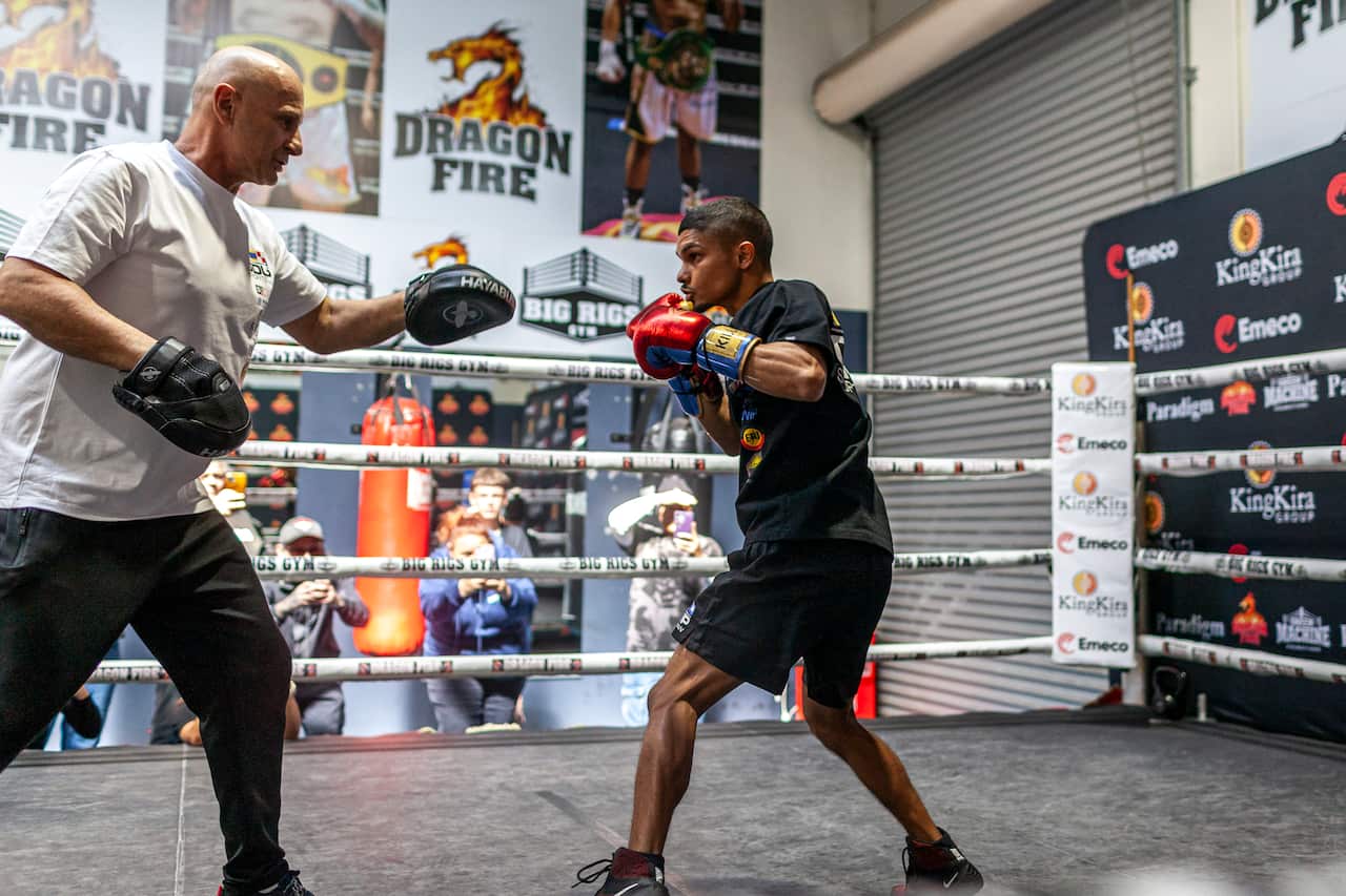 Boxing trainer Angelo Hyder holding the pads for Alex Winwood