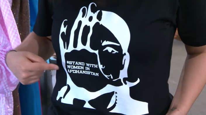 Black T-shirt that says stand with women in Afghanistan