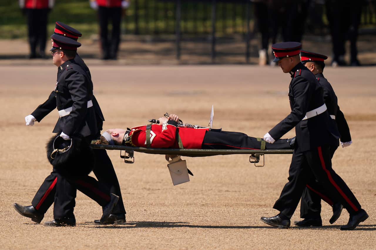 Medical staff carrying a soldier on a stretcher.