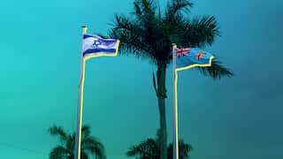 Artwork of the flags of Israel and Fiji flying on flagpoles alongside palm trees set against a blue and green background with geometric shapes.