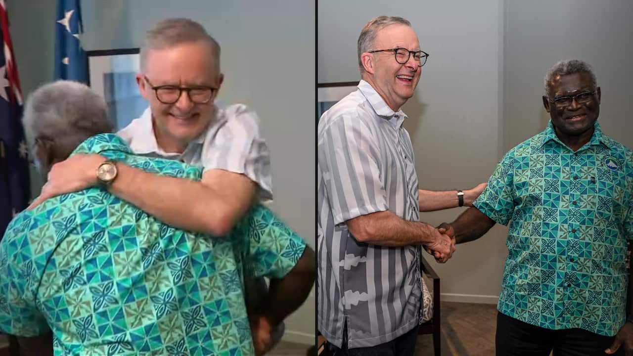 Composite image of Albanese and Sogavare hugging and shaking hands