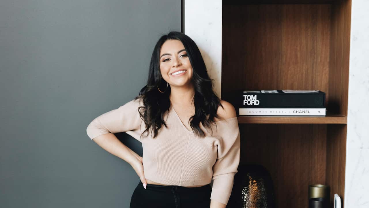 Brisbane-based master brow stylist Mariana Fataccioli smiles in front of the camera