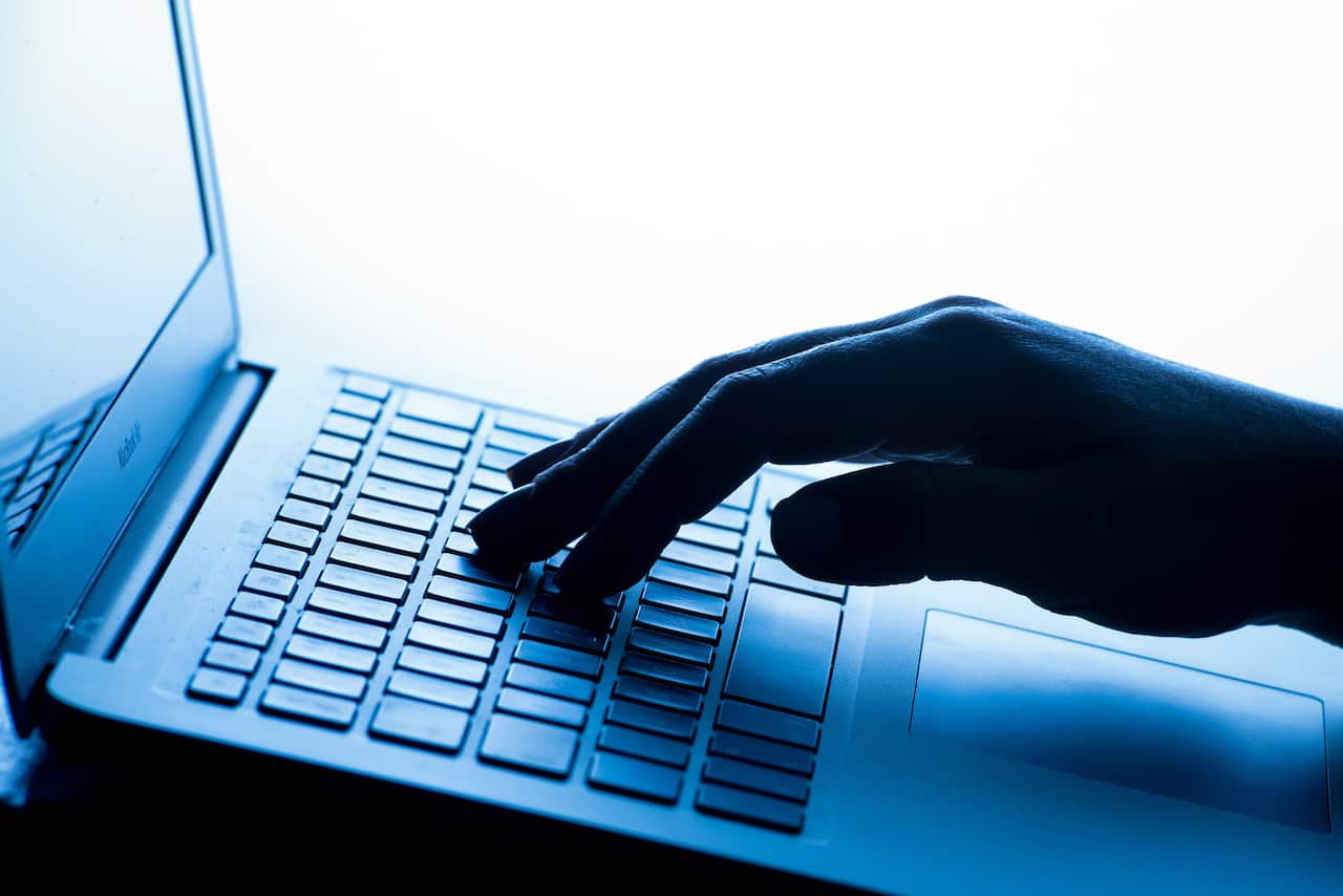 A hand at a keyboard.