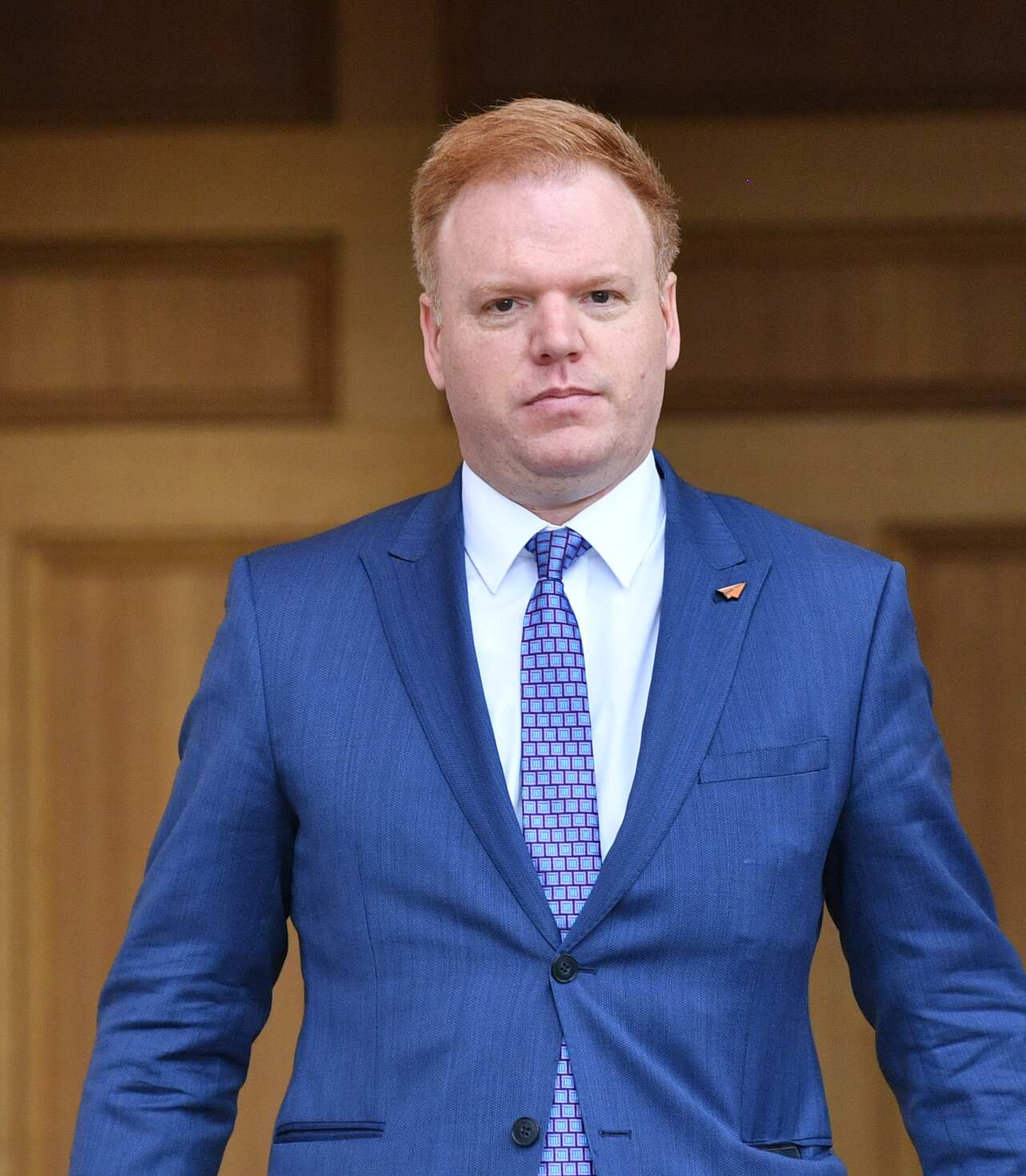 A man wearing a blue suit and tie.
