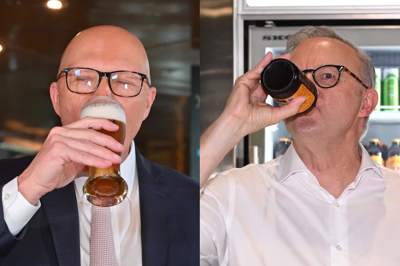 Two men are shown drinking from glasses or bottles, one with a foamy beverage and the other with a dark liquid. Both are wearing glasses.