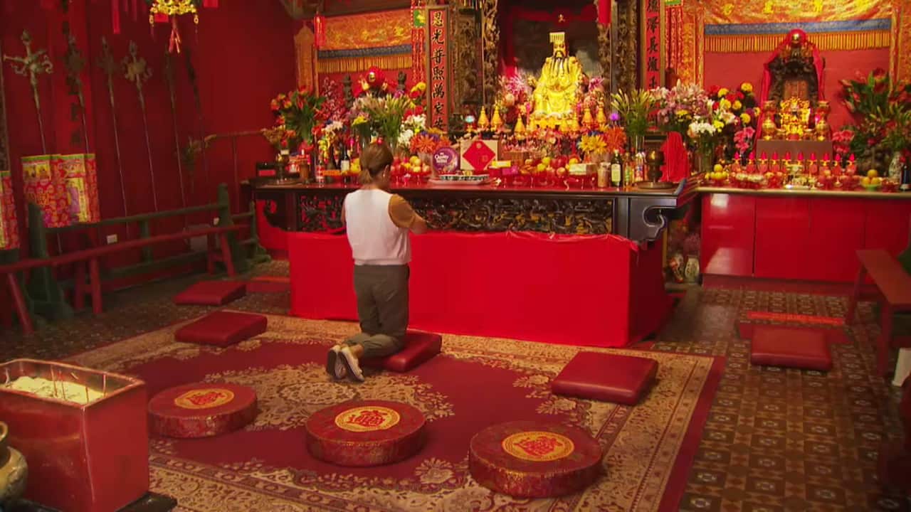 A woman praying at a temple