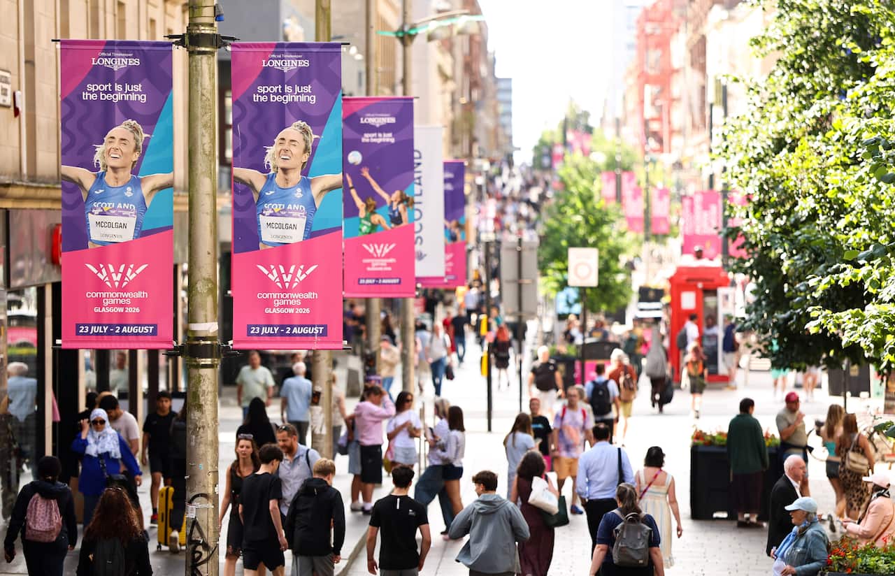 Pink and purple banners on a city street.