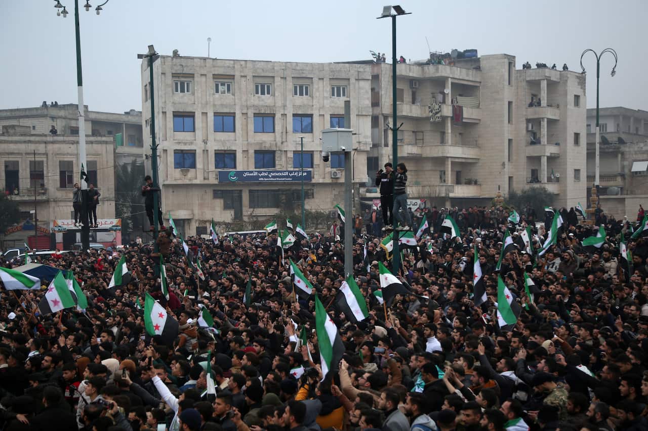 Syrians celebrate the fall of the al-Assad regime in Idlib