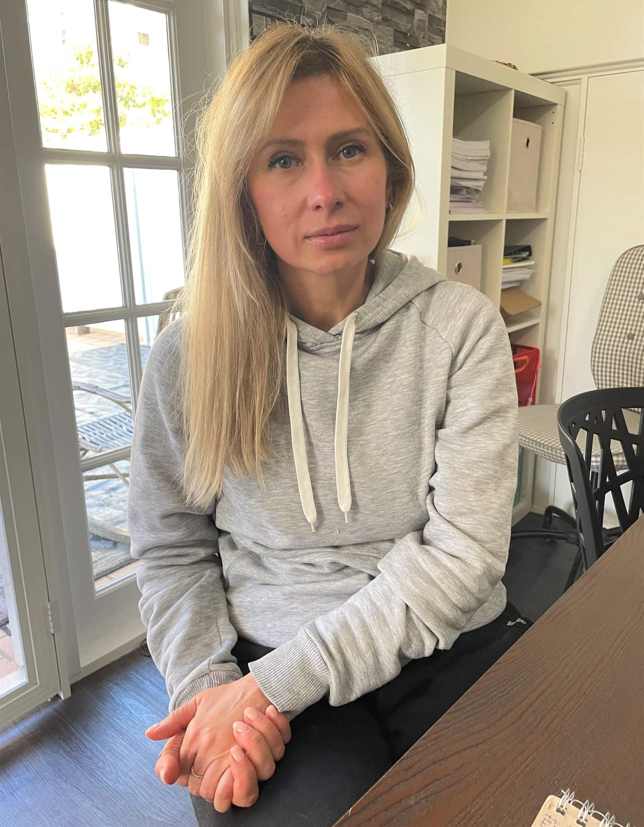 Alla Storozhuk sitting at the dining table.