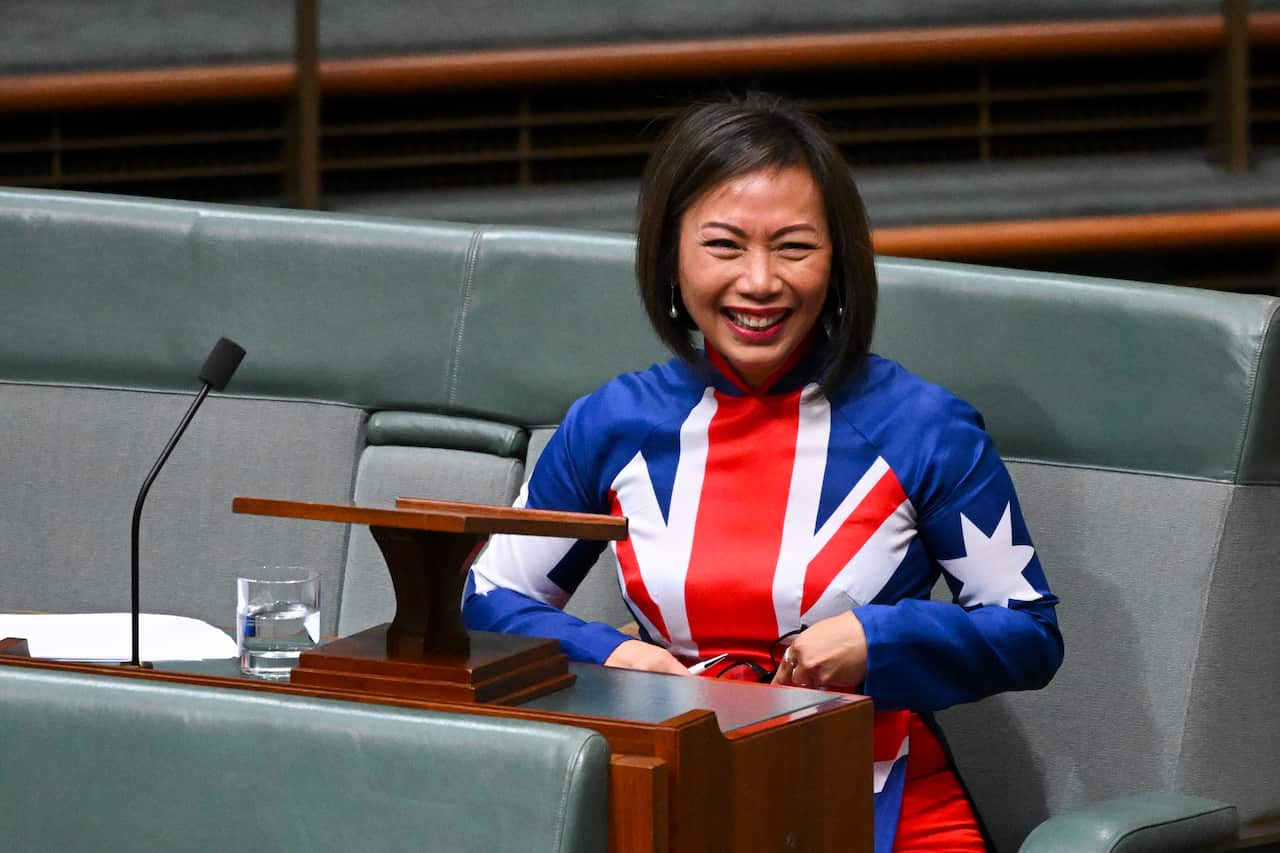Dai Le, wearing an Australian flag dress, smiles in Parliament.