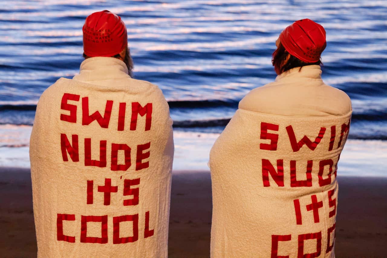 Swimmers gather before the annual nude winter solstice swim during Hobart's Dark Mofo festival at Long Beach in Sandy Bay, Tasmania, Wednesday, 22 June 2022.