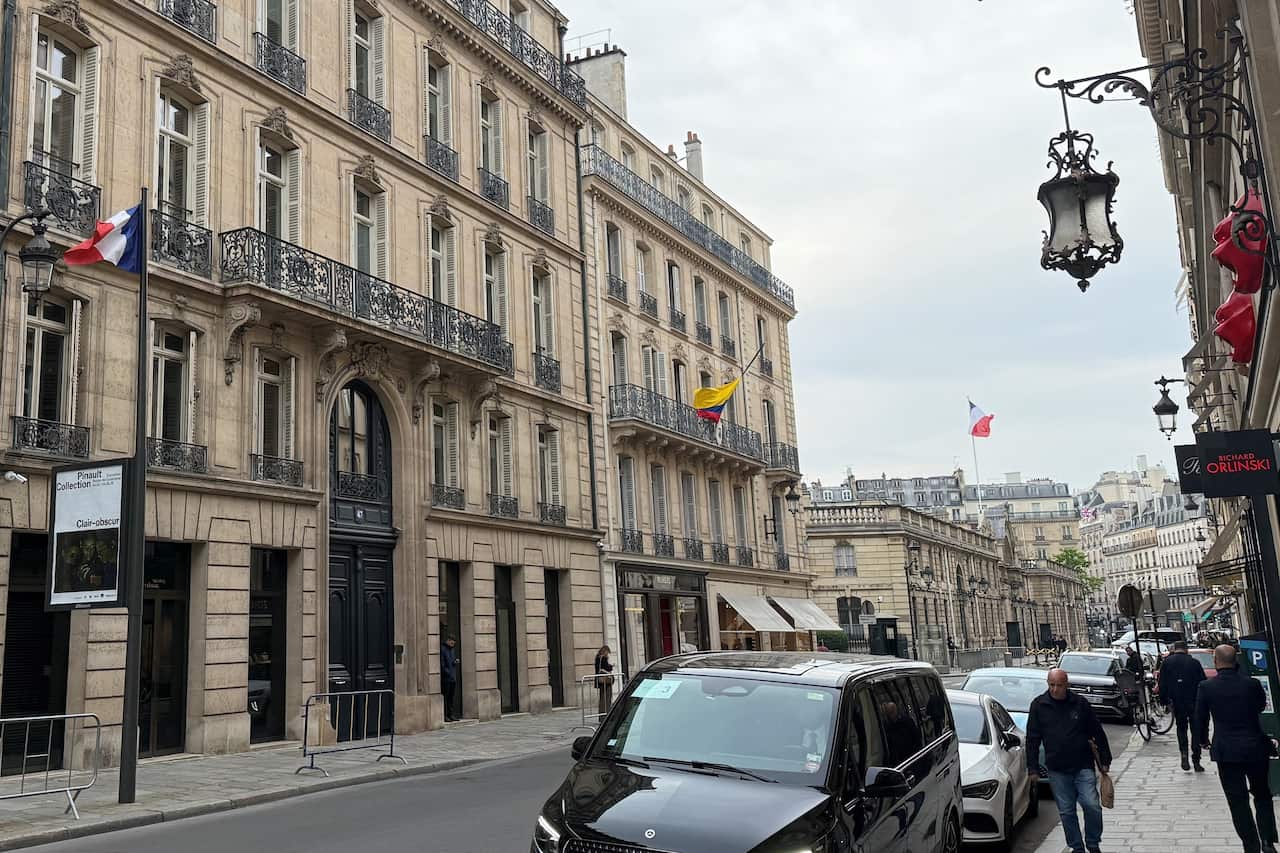 A traditional looking building with a French flag flying outside