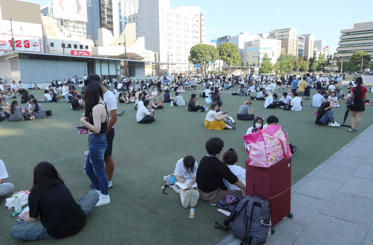 A large group of people congregate in a public square.