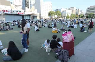 A large group of people congregate in a public square.