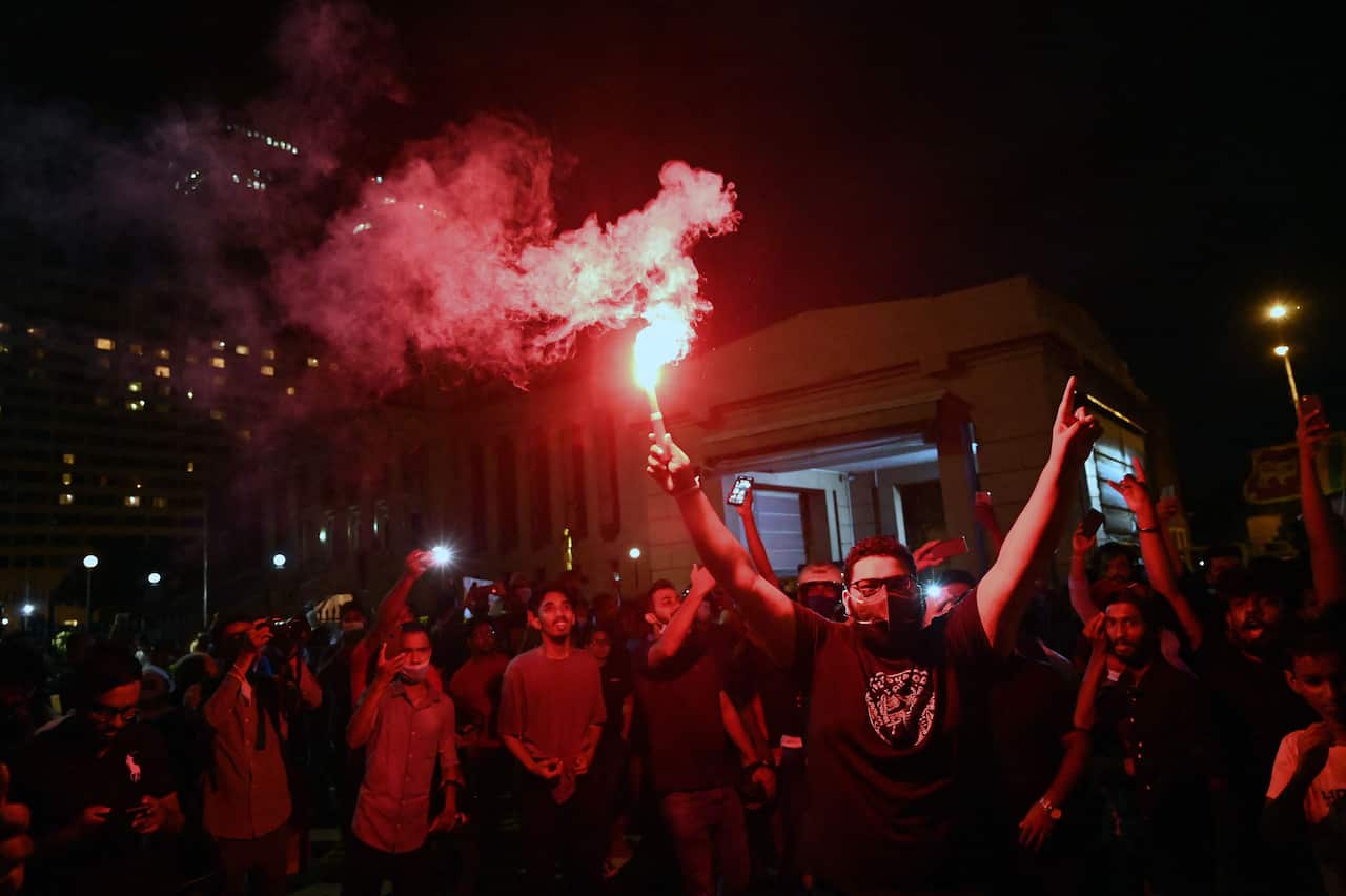 Protestors are seen hold flares during a demonstration.