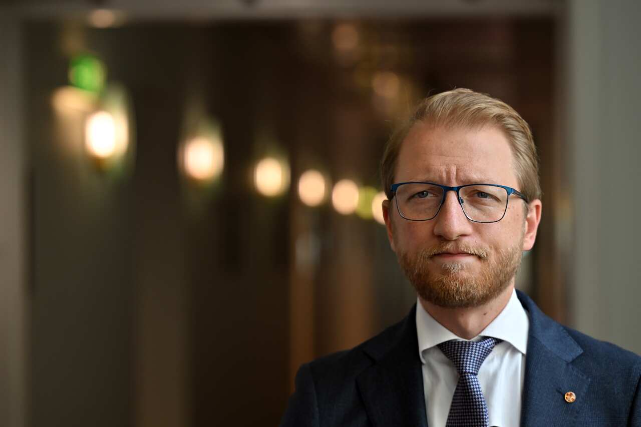 A man dressed in a blue suit and a matching tie.