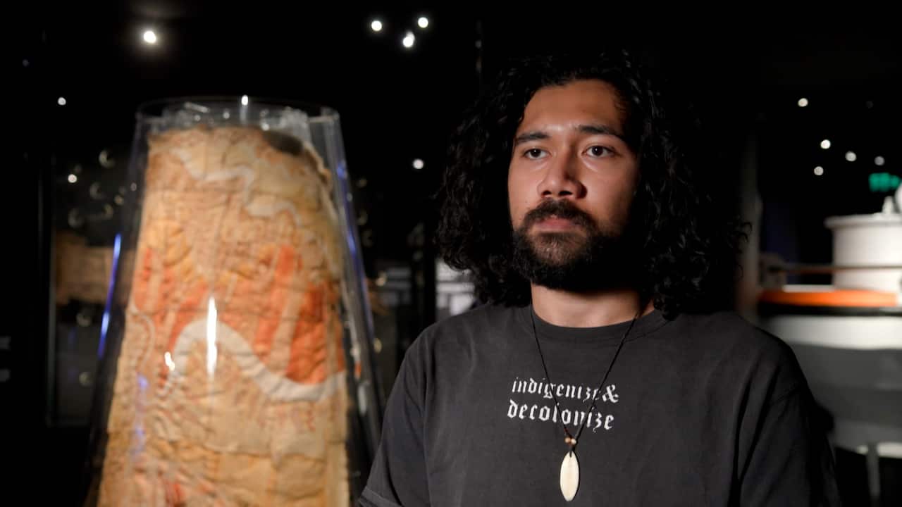 A man with a serious face looks at the camera.