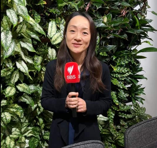 A Japanese woman holding a microphone