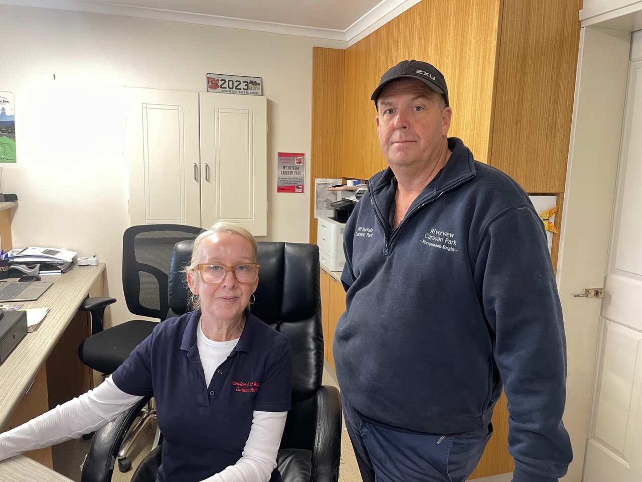 A man and a woman sitting at a desk