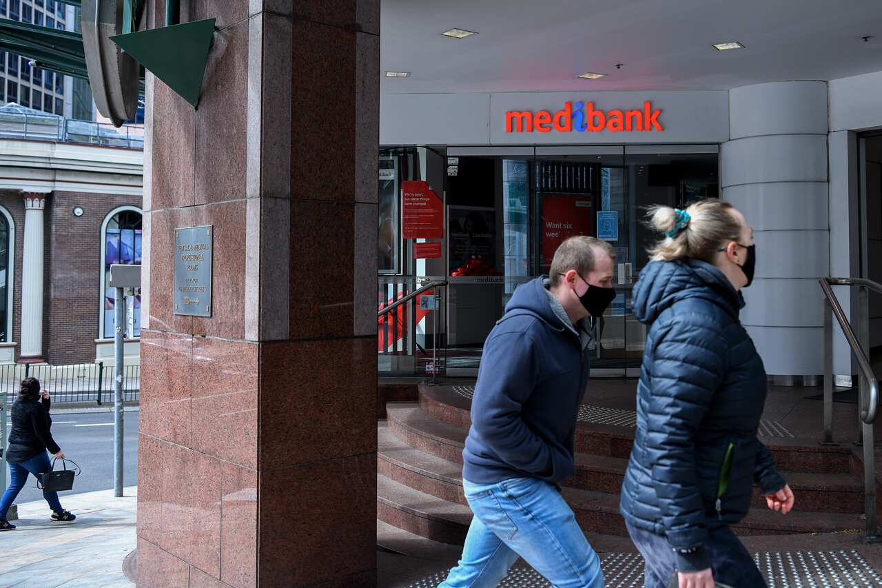 People walking past a Medibank office.