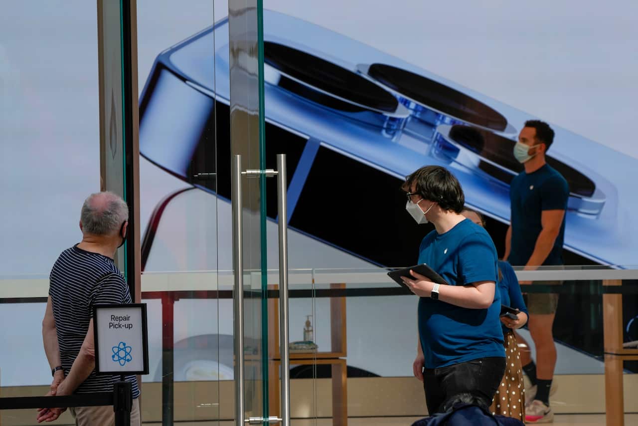 People standing inside an Apple story in Sydney.