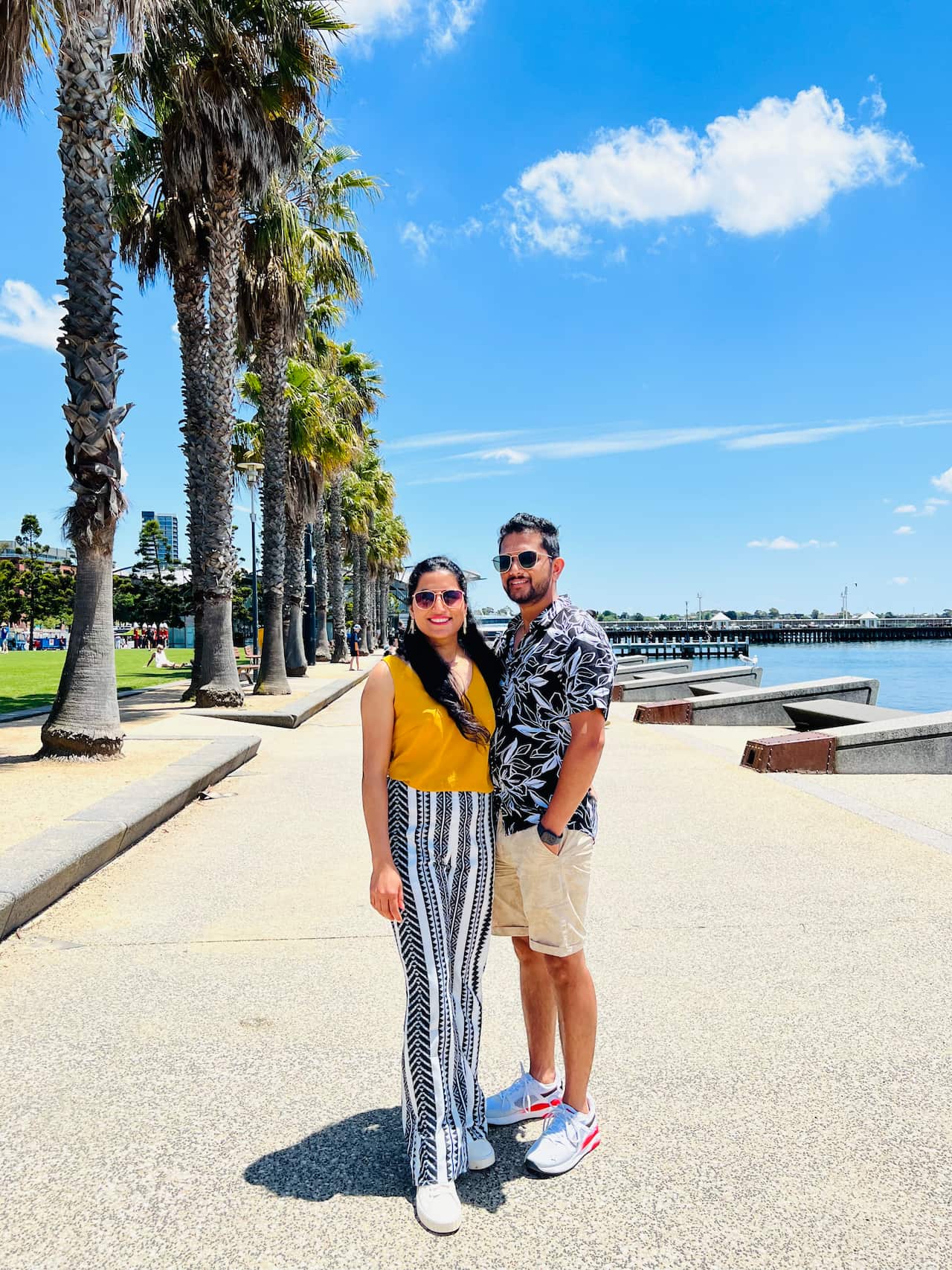 A man and a woman standing by the water's edge.