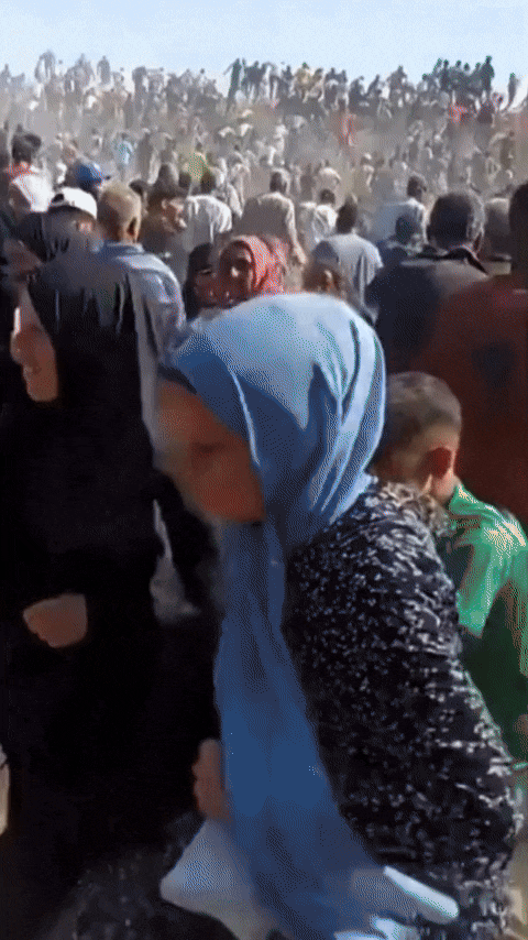 A throng of people is rushing around.