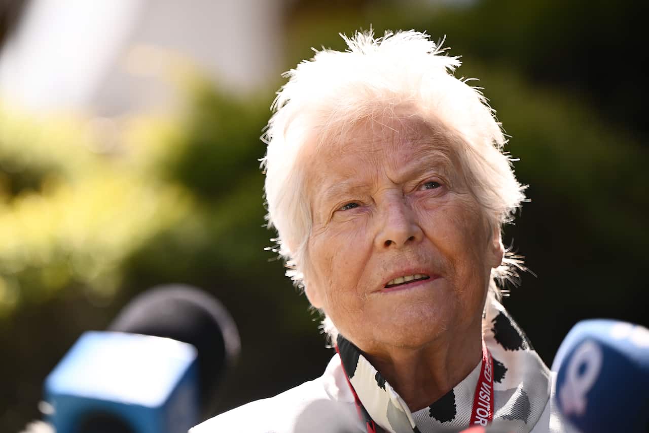 A woman speaks to the media