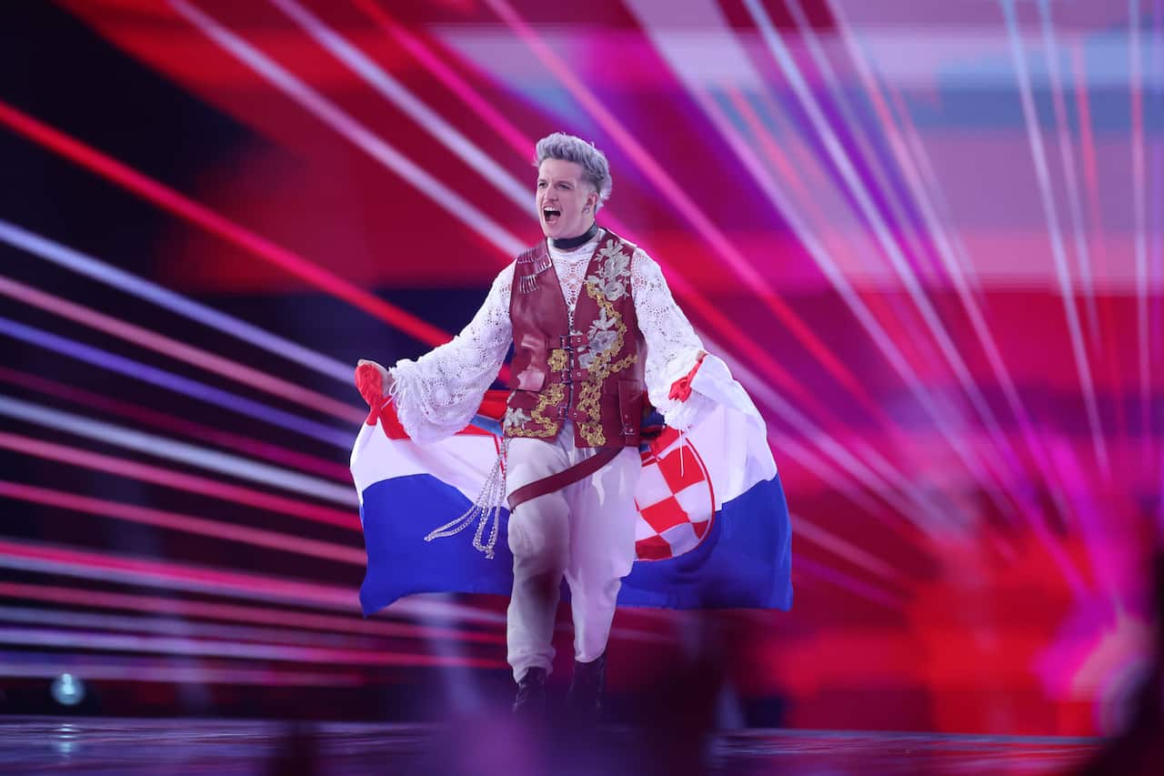 A performer on stage holds a flag