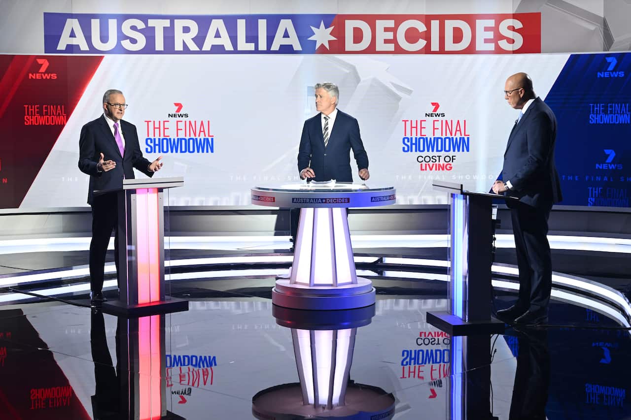 Anthony Albanese and Peter Dutton stand at separate podiums separated by a moderator.