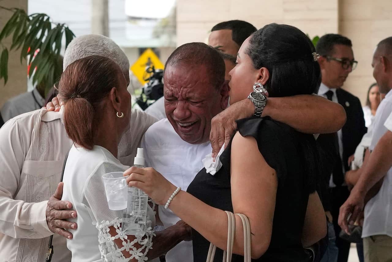 Group of people crying and hugging