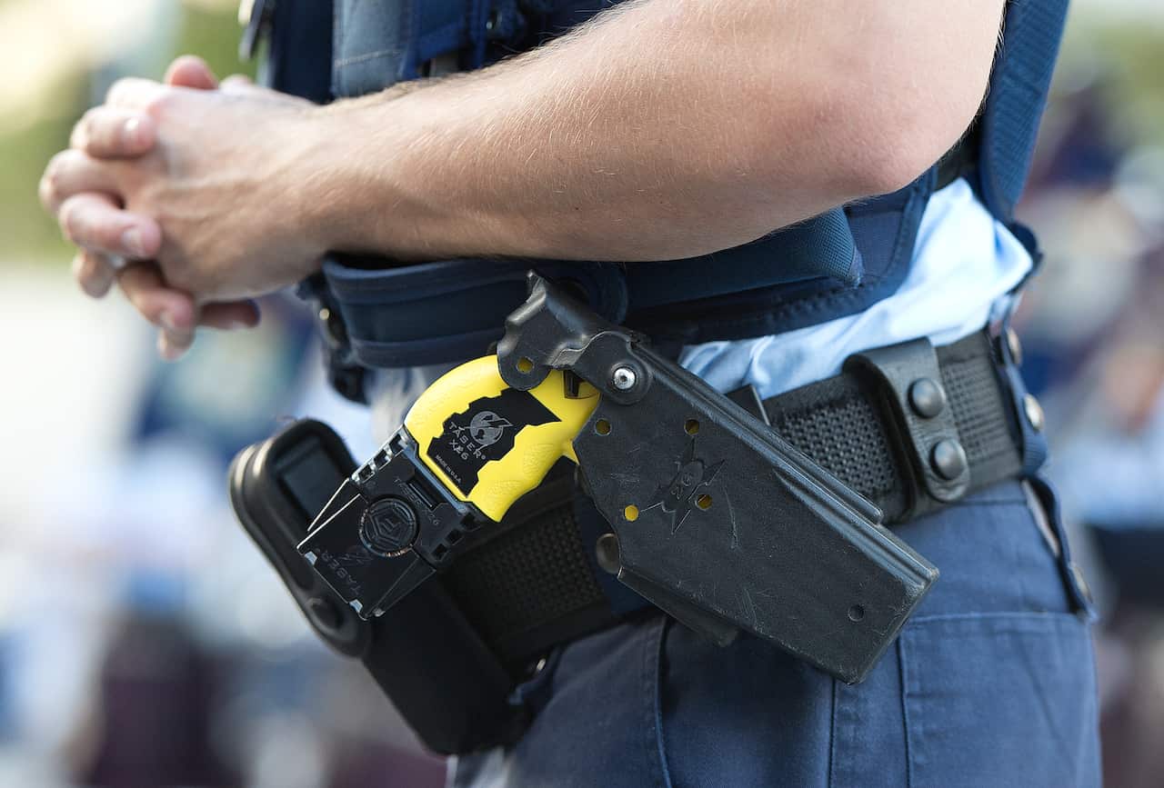 A police officer with a Taser in their belt