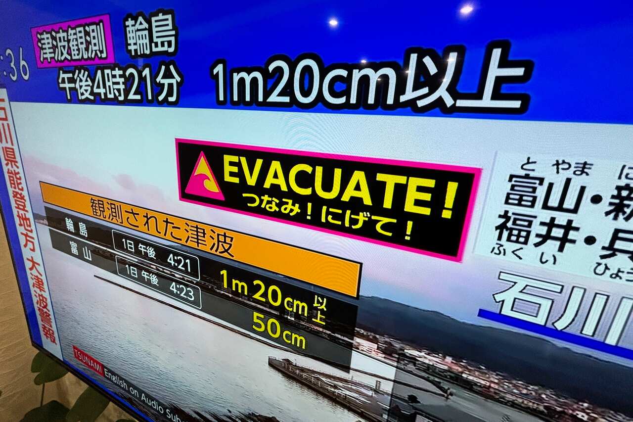 A tsunami warning is shown on TV.