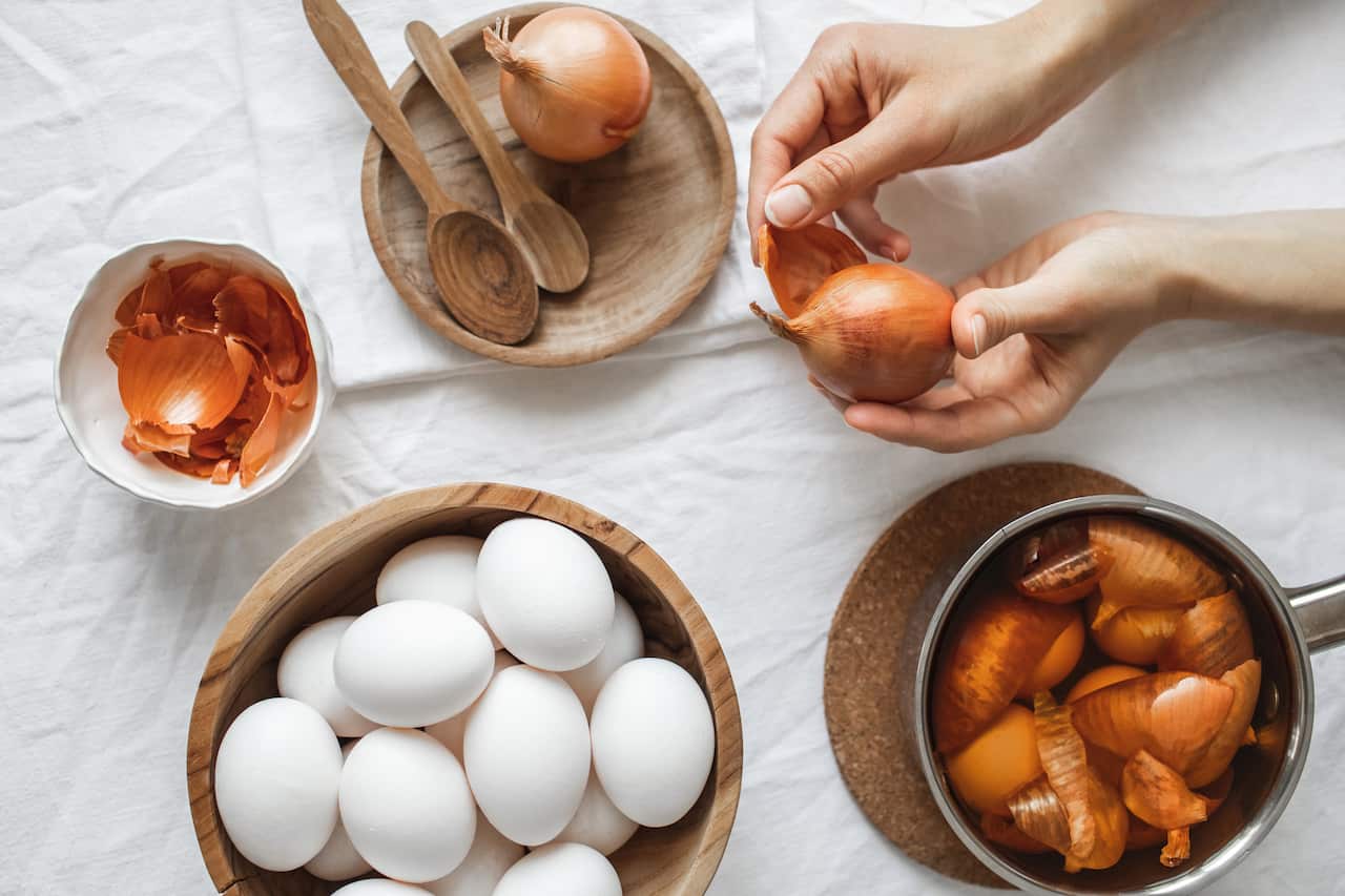 Natural and organic painting eggs for Easter in onion peel. Top view and copy space