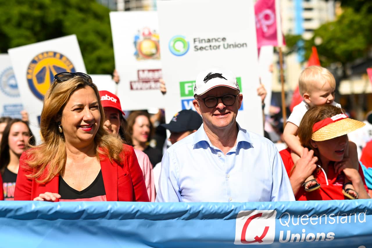 Australian Opposition leader Anthony Albanese and Queensland Premier Annastacia Palaszczuk marching in a crowd.