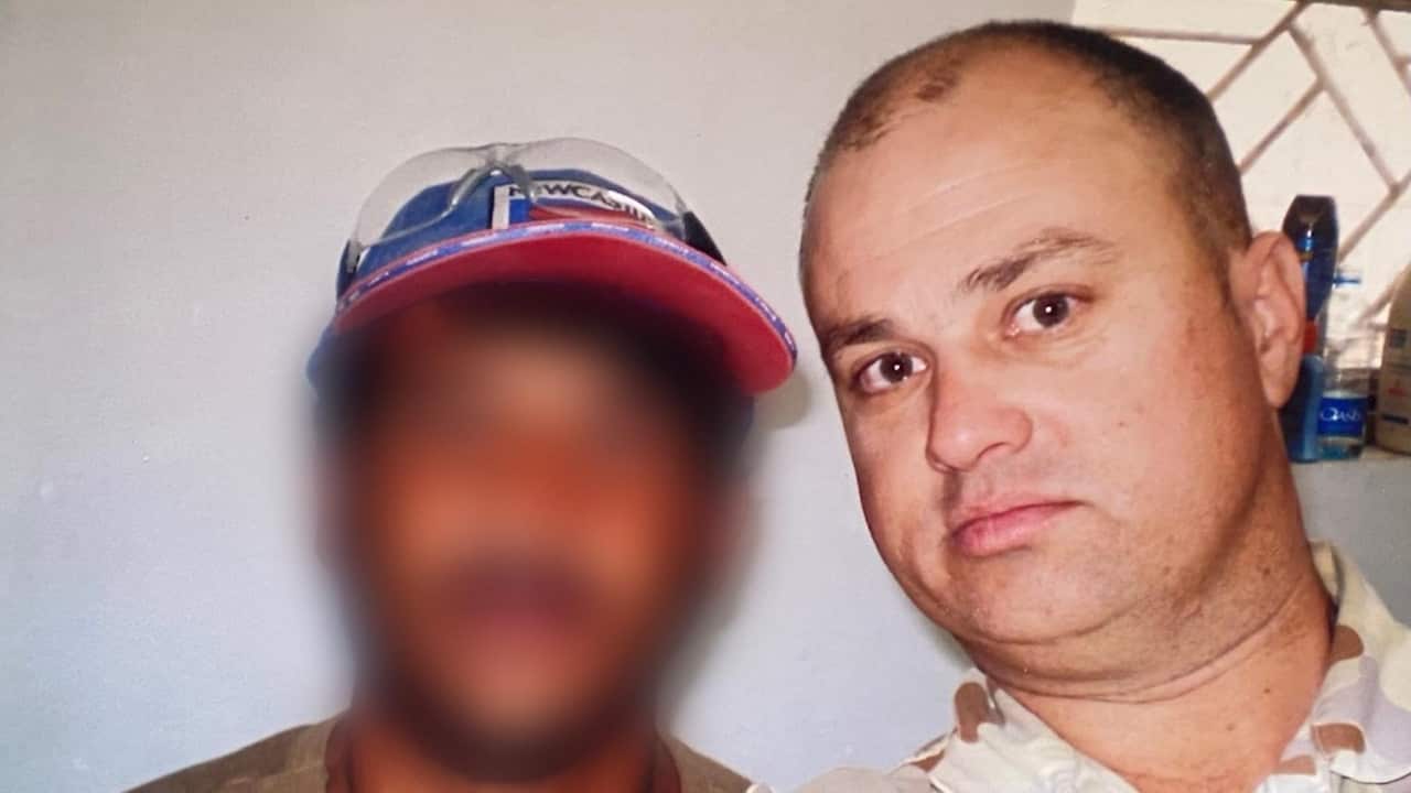 Warren and his Afghan colleague. The colleague's face has been blurred. 