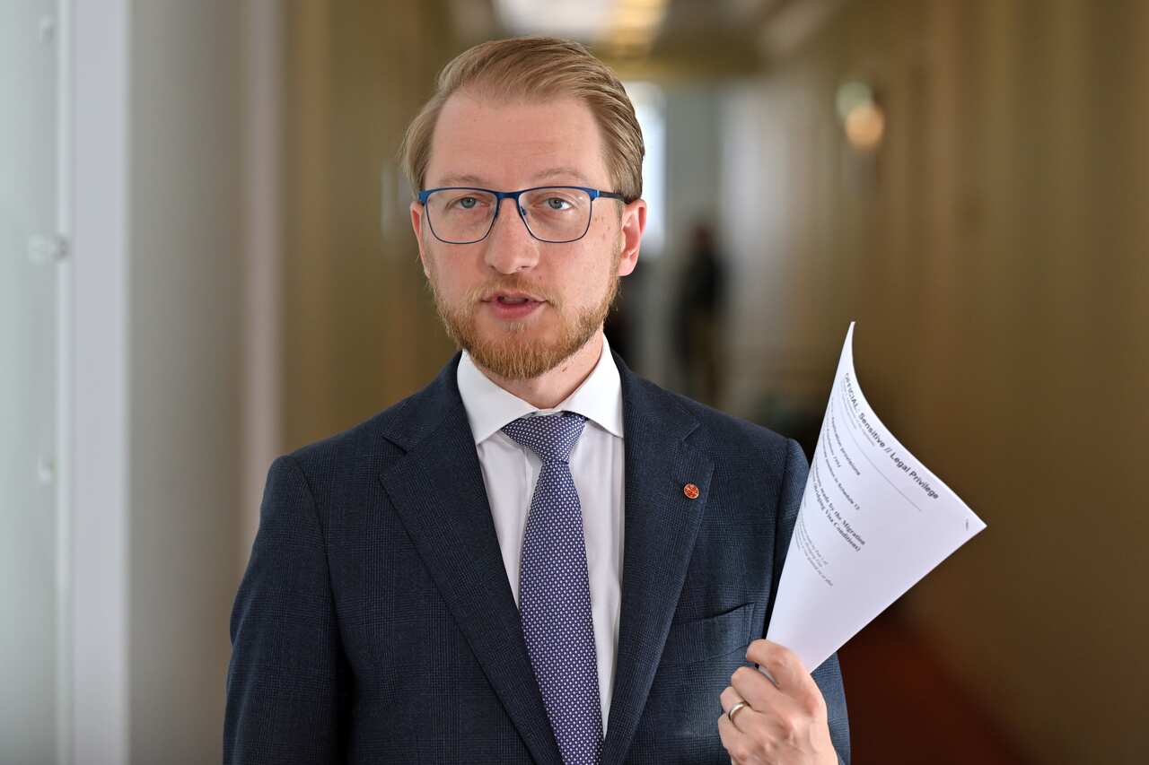 James Paterson holding a piece of paper.