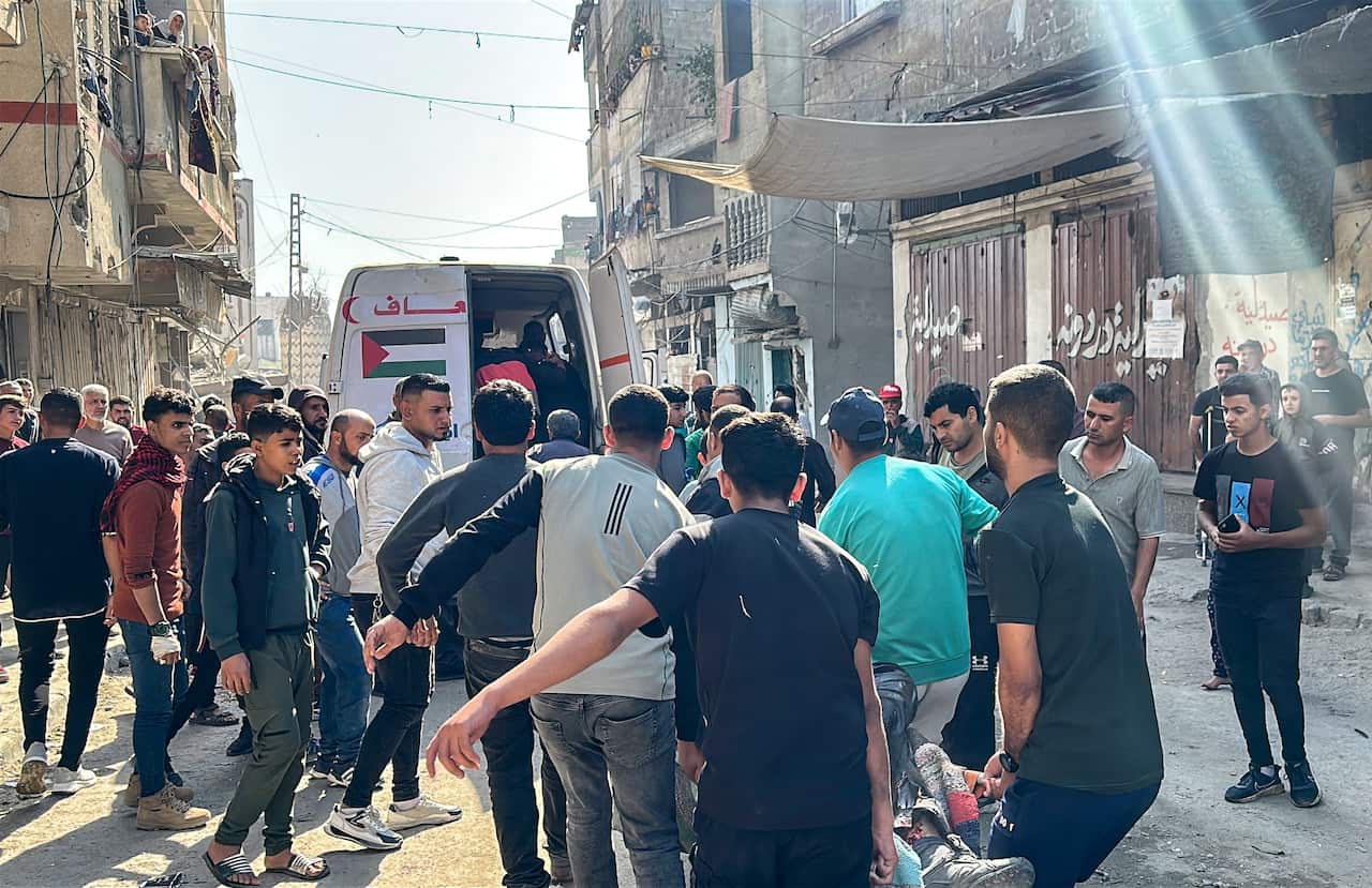 A large group of people helping those injured in an Israeli strike.