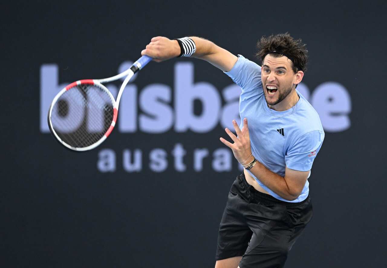 Dominic Thiem raises his racquet as he prepares to serve. 