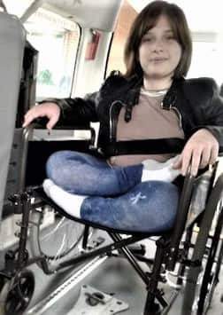 Rita using a wheelchair in specialised transport.