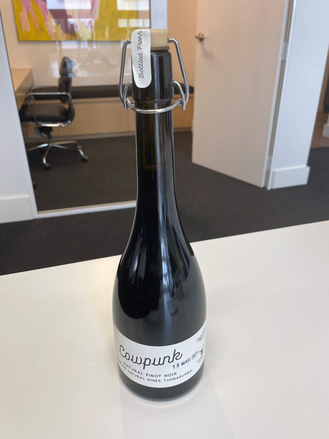 The Cowpunk refillable bottle on a table. 