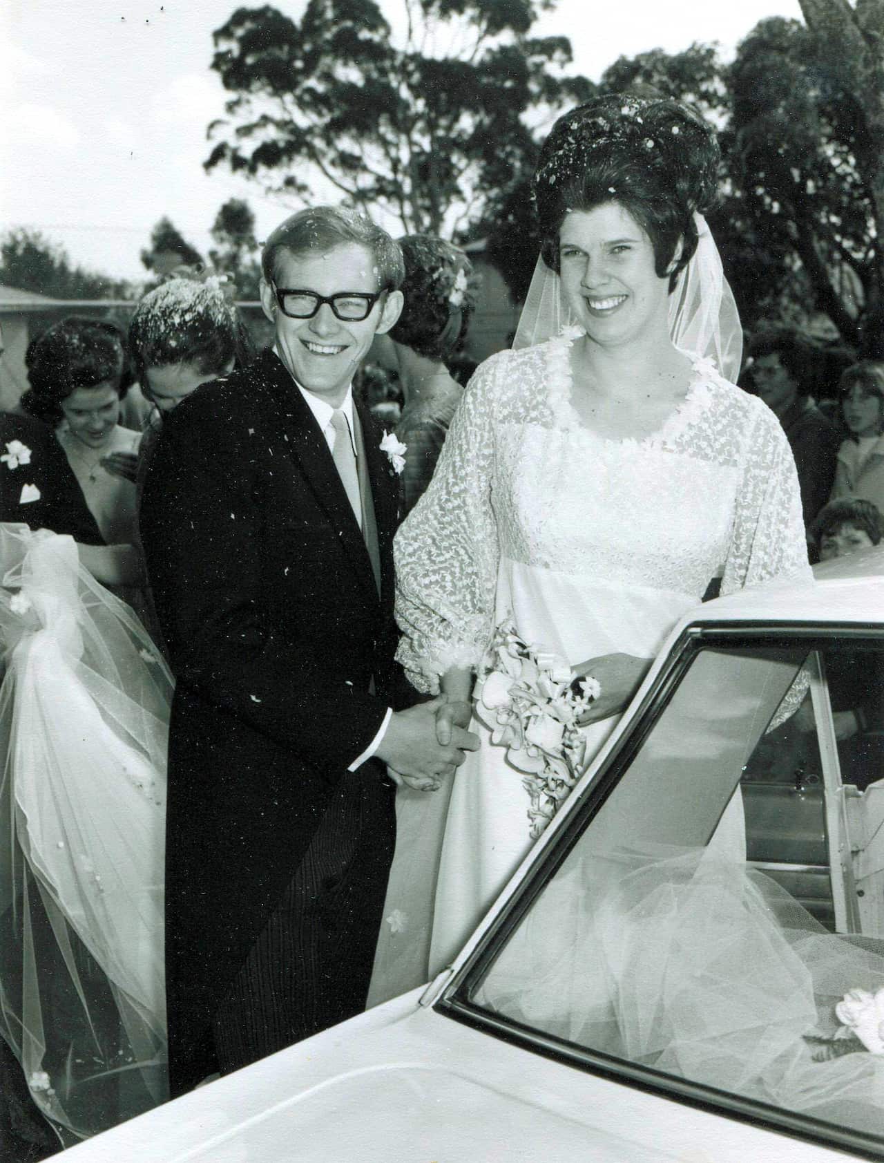 A black and white photo of a man and a woman on their wedding day.