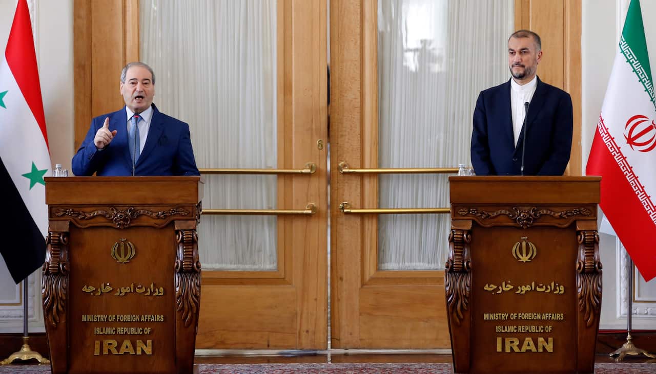 Two men standing at podiums.