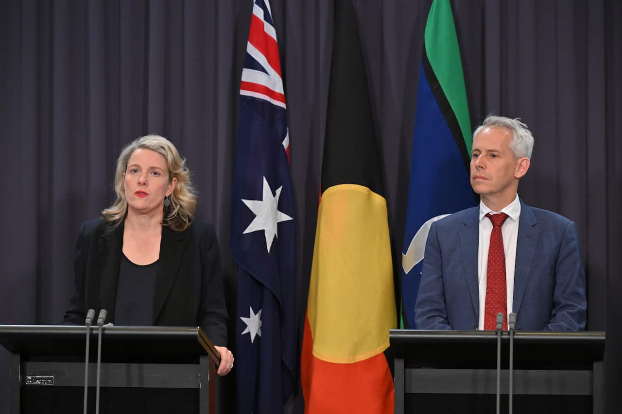 Two people standing in front of podiums
