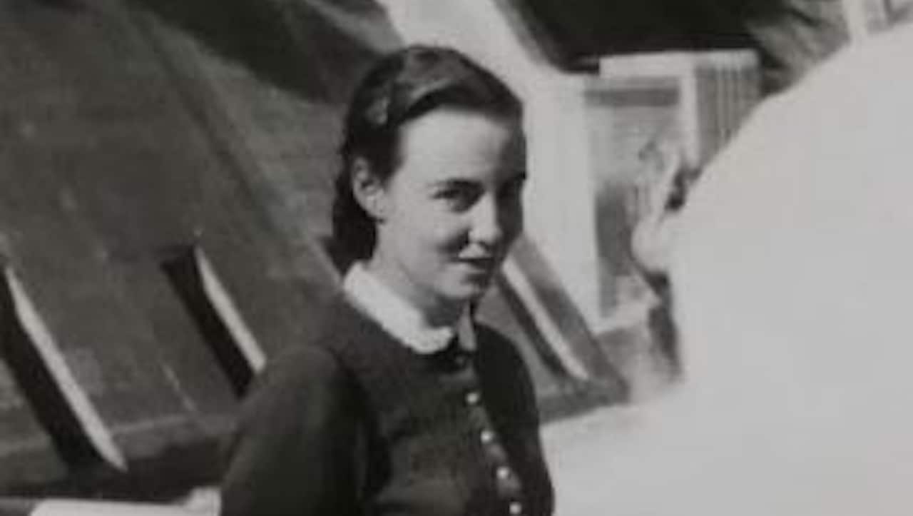 A young woman in a black and white photo wearing a dress.