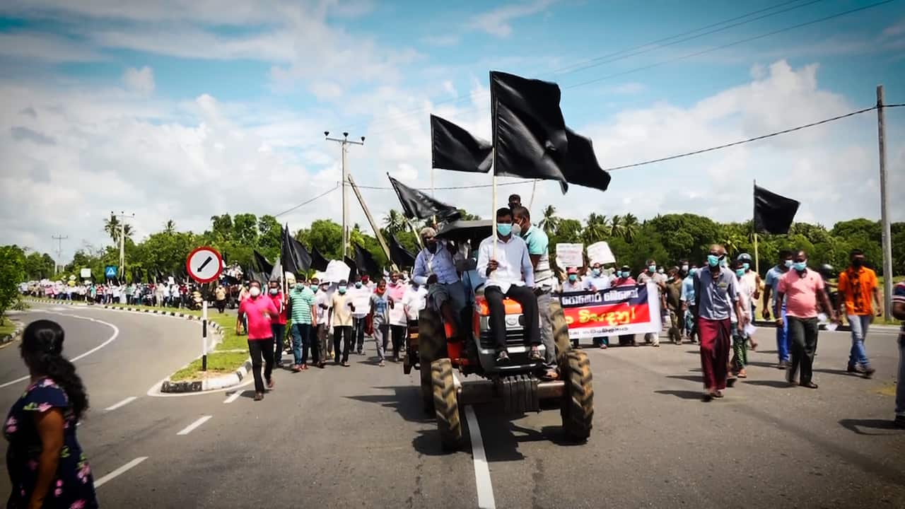 A protester sitting on a tractor.